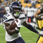 
              Seattle Seahawks wide receiver Dareke Young (83) runs past Pittsburgh Steelers linebacker Mark Robinson, right, during the second half of a preseason NFL football game, Saturday, Aug. 13, 2022, in Pittsburgh. (AP Photo/Fred Vuich)
            
