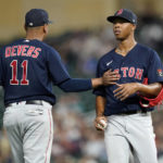 
              Boston Red Sox starting pitcher Brayan Bello, right, is supported by third baseman Rafael Devers (11), left, after allowing a run during the fourth inning of a baseball game against the Minnesota Twins, Monday, Aug. 29, 2022, in Minneapolis. (AP Photo/Abbie Parr)
            