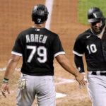 
              Chicago White Sox's Jose Abreu (79) and Yoan Moncada (10) celebrate after scoring when Gavin Sheets reached on a fielding error during the sixth inning of a baseball game against the Kansas City Royals Wednesday, Aug. 10, 2022, in Kansas City, Mo. (AP Photo/Charlie Riedel)
            