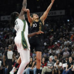 
              Las Vegas Aces guard Kelsey Plum (10) shoots around Seattle Storm's Tina Charles during the first half in Game 1 of a WNBA basketball semifinal playoff series Sunday, Aug. 28, 2022, in Las Vegas. (AP Photo/John Locher)
            