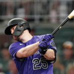 
              Colorado Rockies' C.J. Cron drives in a run with a base hit during the fourth inning of the team's baseball game against the Atlanta Braves on Tuesday, Aug. 30, 2022, in Atlanta. (AP Photo/John Bazemore)
            