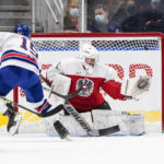 
              United States' Matthew Coronato (15) hits the post as Austria's goalie Leon Sommer (1) tries to make a save during the first period of an IIHF World Junior Hockey Championship game in Edmonton, Alberta, Saturday, Aug. 13, 2022. (Jason Franson/The Canadian Press via AP)
            