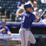 
              Texas Rangers' Mark Mathias follows the flight of his double to drive in three runs off Colorado Rockies starting pitcher Jose Urena in the second inning of a baseball game Wednesday, Aug. 24, 2022, in Denver. (AP Photo/David Zalubowski)
            