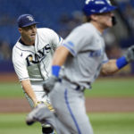 
              Tampa Bay Rays starting pitcher Shane McClanahan, left, flips the ball to first in time to throw out Kansas City Royals' Nate Eaton during the third inning of a baseball game Friday, Aug. 19, 2022, in St. Petersburg, Fla. (AP Photo/Chris O'Meara)
            