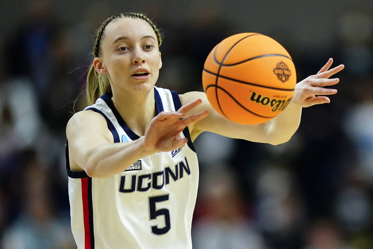 FILE - Connecticut guard Paige Bueckers (5) passes the ball during the first quarter of an NCAA col...