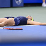 
              Caroline Garcia, of France, lies on the court as she defeats Petra Kvitova, of the Czech Republic, during the women's singles final of the Western & Southern Open tennis tournament, Sunday, Aug. 21, 2022, in Mason, Ohio. (AP Photo/Aaron Doster)
            