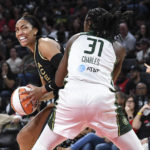 
              Las Vegas Aces forward A'ja Wilson, left, looks to shoot past Seattle Storm center Tina Charles (31) during the first half of a WNBA basketball game Sunday, Aug. 14, 2022, in Las Vegas. (AP Photo/Sam Morris)
            