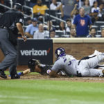 
              Colorado Rockies catcher Elias Diaz (35) tags New York Mets' Jeff McNeil out at home during the sixth inning of a baseball game on Friday, Aug. 26, 2022, in New York. (AP Photo/Jessie Alcheh)
            