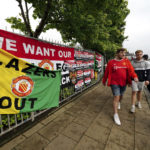 
              Fans walk to the Old Trafford ground, Manchester, England, Monday Aug. 22, 2022, ahead of an organised protest against the Manchester United owners before the Premier League match between Manchester United and Liverpool. (Peter Byrne/PA via AP)
            