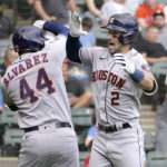 
              Houston Astros' Alex Bregman, right, celebrates with Yordan Alvarez after they scored on Bregman's two-run homer off Chicago White Sox relief pitcher Vince Velasquez during the fourth inning of a baseball game Thursday, Aug. 18, 2022, in Chicago. (AP Photo/Charles Rex Arbogast)
            