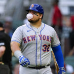 
              New York Mets' Daniel Vogelbach blows a bubble as he walks back to the dugout after striking out during the second inning of the team's baseball game against the Atlanta Braves on Tuesday, Aug. 16, 2022 in Atlanta. (AP Photo/John Bazemore)
            