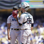 
              Miami Marlins starting pitcher Sandy Alcantara, left, talks with catcher Jacob Stallings on the mound after giving up a single to Los Angeles Dodgers' Freddie Freeman during the third inning of a baseball game Sunday, Aug. 21, 2022, in Los Angeles. (AP Photo/Marcio Jose Sanchez)
            