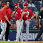 
              Cincinnati Reds' Mike Moustakas is checked out by team personnel before leaving the game in the eighth inning of a baseball game against the Philadelphia Phillies, Tuesday, Aug. 23, 2022, in Philadelphia. (AP Photo/Matt Slocum)
            