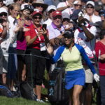 
              Paula Reto, of South Africa, acknowledges the crowd as she approaches the 18th green  during the Canadian Pacific Women's Open golf tournament in Ottawa, on Sunday, Aug. 28, 2022. (Adrian Wyld/The Canadian Press via AP)
            