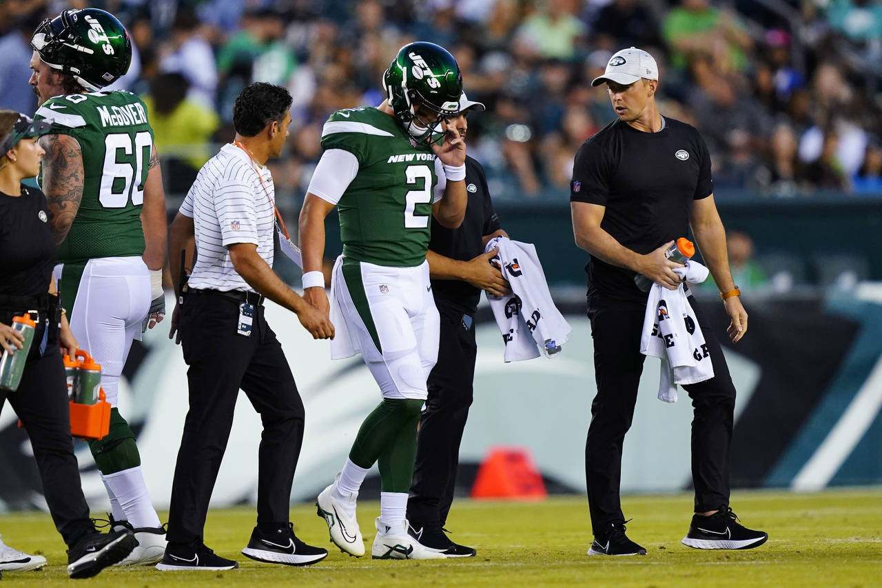 New York Jets' Zach Wilson is taken off the field after an injury during the first half of a presea...