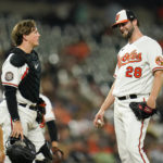 
              Baltimore Orioles starting pitcher Jordan Lyles (28) talks to catcher Adley Rutschman during the seventh inning of a baseball game against the Chicago White Sox, Thursday, Aug. 25, 2022, in Baltimore. (AP Photo/Julio Cortez)
            