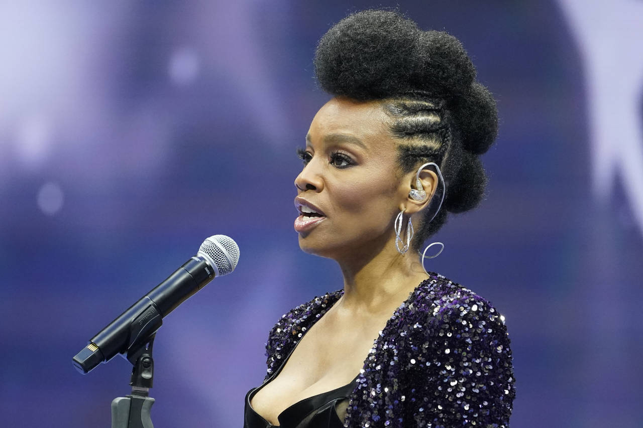 Anika Noni Rose sings the national anthem before a match between Serena Williams, of the United Sta...