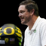 
              FILE - Oregon head coach Dan Lanning speaks during Pac-12 Conference men's NCAA college football media day Friday, July 29, 2022, in Los Angeles. Oregon first-year coach Lanning isn't dropping any clues about his starting quarterback this season. Fall camp has been a battle behind closed doors between transfer Bo Nix, redshirt freshmen Ty Thompson and Jay Butterfield. (AP Photo/Damian Dovarganes, File)
            