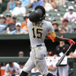 
              Pittsburgh Pirates' Oneil Cruz (15) swings out of his helmet on a ball thrown by Baltimore Orioles starting pitcher Spenser Watkins during the second inning of a baseball game, Sunday, Aug 7, 2022, in Baltimore. (AP Photo/Terrance Williams)
            