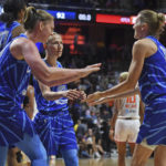 
              Chicago Sky guard Allie Quigley, right, congratulates teammates Emma Meesseman (33), Azurá Stevens (30), and Courtney Vandersloot (22) as they win in overtime over the Connecticut Sun in a WNBA basketball game in Uncasville, Conn., Sunday, July 31, 2022. (Sean D. Elliot/The Day via AP)
            