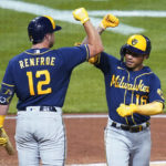 
              Milwaukee Brewers' Kolten Wong (16) celebrates with Hunter Renfroe (12) after hitting the third of three Brewers home runs off Pittsburgh Pirates starting pitcher Bryse Wilson during the sixth inning of a baseball game Tuesday, Aug. 2, 2022, in Pittsburgh. (AP Photo/Keith Srakocic)
            