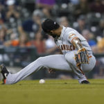 
              San Francisco Giants relief pitcher Camilo Doval falls down trying to field a Detroit Tigers' Javier Baez ground ball in the ninth inning of a baseball game in Detroit, Tuesday, Aug. 23, 2022. (AP Photo/Paul Sancya)
            