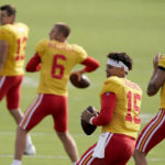 
              Kansas City Chiefs quarterbacks Dustin Crum (13), Shane Buechele (6), Patrick Mahomes (15) and Chad Henne (4) participate in a drill during NFL football training camp Sunday, Aug. 7, 2022, in St. Joseph, Mo. (AP Photo/Charlie Riedel)
            