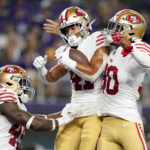 
              San Francisco 49ers defensive back Tayler Hawkins, center, celebrates with teammates linebacker Segun Olubi, left, and safety George Odum, right, after intercepting a pass during the second half of a preseason NFL football game against the Minnesota Vikings, Saturday, Aug. 20, 2022, in Minneapolis. (AP Photo/Abbie Parr)
            