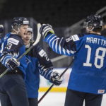 
              Finland's Roby Jarventie (13), Aleksi Heimosalmi (21) and Joel Maatta (18) celebrate a goal against Germany during the third period of an IIHF World Junior Hockey Championship quarterfinal game in Edmonton, Wednesday Aug. 17, 2022. (Jason Franson/The Canadian Press via AP)
            
