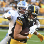 
              Detroit Lions linebacker Derrick Barnes (55) tries to bring down Pittsburgh Steelers tight end Pat Freiermuth (88) after he made a catch during the first half of an NFL preseason football game, Sunday, Aug. 28, 2022, in Pittsburgh. (AP Photo/Fred Vuich)
            