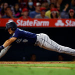 Sam Haggerty #0 of the Seattle Mariners slides safely into home plate against the Los Angeles Angels in the ninth inning at Angel Stadium of Anaheim on August 15, 2022 in Anaheim, California. (Photo by Ronald Martinez/Getty Images)