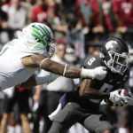 Washington State wide receiver Renard Bell (9) tries to get past Oregon linebacker Noah Sewell (1) during the first half of an NCAA college football game, Saturday, Sept. 24, 2022, in Pullman, Wash. (AP Photo/Young Kwak)
