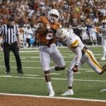 
              Texas running back Roschon Johnson (2) scores a touchdown against Louisiana-Monroe cornerback Lu Tillery (0) during the first half an NCAA college football game Saturday, Sept. 3, 2022, in Austin, Texas. (AP Photo/Michael Thomas)
            