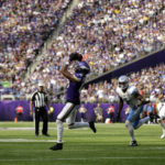 
              Minnesota Vikings wide receiver Justin Jefferson (18) catches a pass ahead of Detroit Lions safety DeShon Elliott (5) during the second half of an NFL football game, Sunday, Sept. 25, 2022, in Minneapolis. (AP Photo/Andy Clayton-King)
            
