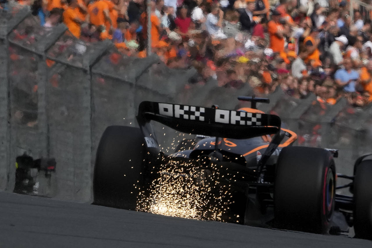 Mclaren driver Daniel Ricciardo of Australia leaves sparks behind during the first practice session...