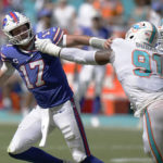 
              Miami Dolphins defensive end Emmanuel Ogbah (91) grabs Buffalo Bills quarterback Josh Allen (17) during the second half of an NFL football game, Sunday, Sept. 25, 2022, in Miami Gardens, Fla. (AP Photo/Wilfredo Lee )
            