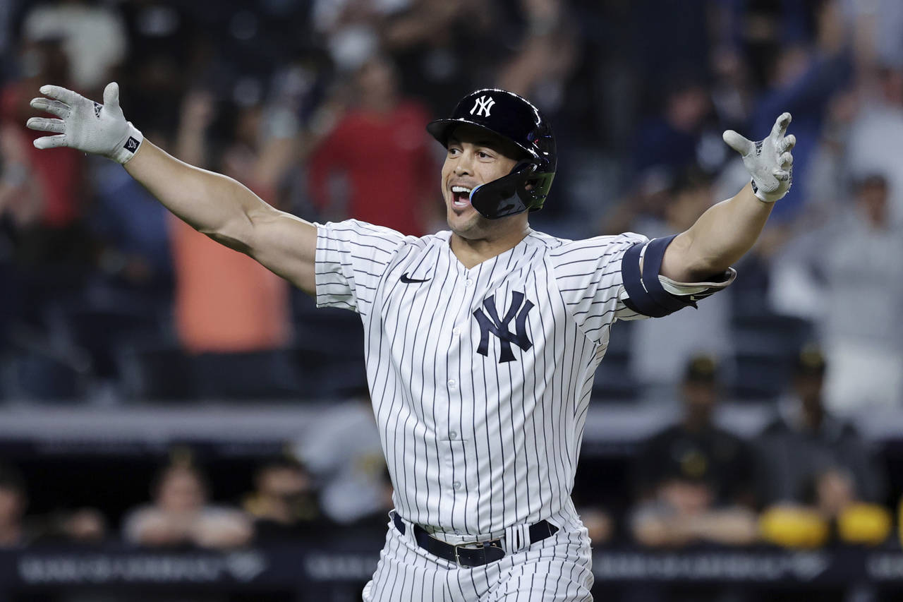 New York Yankees' Giancarlo Stanton reacts after hitting  grand slam against the Pittsburgh Pirates...