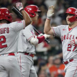 
              Los Angeles Angels' Mike Trout, right, celebrates his three-run home run with Luis Rengifo (2) and Shohei Ohtani, center, during the second inning of a baseball game against the Houston Astros, Saturday, Sept. 10, 2022, in Houston. (AP Photo/Eric Christian Smith)
            