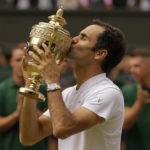 
              FILE - In this July 16, 2017, file photo, Switzerland's Roger Federer kisses the trophy after defeating Croatia's Marin Cilic to win the Men's Singles final match at the Wimbledon Tennis Championships in London. Federer announced Thursday, Sept.15, 2022 he is retiring from tennis. (AP Photo/Alastair Grant, File)
            