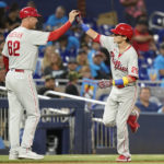 
              Philadelphia Phillies' Nick Maton is met by third base coach Dusty Wathan (62) after hitting a two-run home run during the seventh inning of a baseball game against the Miami Marlins, Tuesday, Sept. 13, 2022, in Miami. The Phillies won 2-1. (AP Photo/Lynne Sladky)
            