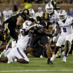 
              Missouri running back Nathaniel Peat, center, runs with the ball as Louisiana Tech defensive back Eric Randall (1) and Hugh Davis (9) defend during the first half of an NCAA college football game Thursday, Sept. 1, in Columbia, Mo. (AP Photo/L.G. Patterson)
            