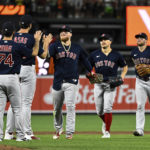 
              Boston Red Sox players greet each other after defeating the Baltimore Orioles 17-4 in a baseball game, Saturday, Sept. 10, 2022, in Baltimore. (AP Photo/Terrance Williams)
            