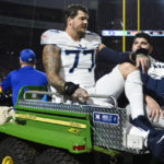 
              Tennessee Titans offensive tackle Taylor Lewan (77) is carted off the field during the first half of an NFL football game against the Buffalo Bills, Monday, Sept. 19, 2022, in Orchard Park, N.Y. (AP Photo/Adrian Kraus)
            