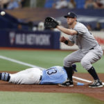 
              Tampa Bay Rays' Manuel Margot slides safely back to first on a pickoff attempt from New York Yankees pitcher Domingo German to first baseman DJ LeMahieu during the first inning of a baseball game Friday, Sept. 2, 2022, in St. Petersburg, Fla. (AP Photo/Scott Audette)
            