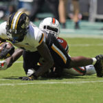 
              Southern Miss wide receiver Jason Brownlee is taken down by Miami cornerback DJ Ivey (8) during the second half of an NCAA college football game, Saturday, Sept. 10, 2022, in Miami Gardens, Fla. (AP Photo/Wilfredo Lee)
            