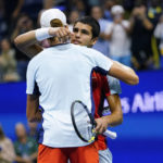 
              Carlos Alcaraz, of Spain, right, hugs Jannik Sinner, of Italy, after Alcaraz won their match in the quarterfinals of the U.S. Open tennis championships, early Thursday, Sept. 8, 2022, in New York. (AP Photo/Frank Franklin II)
            