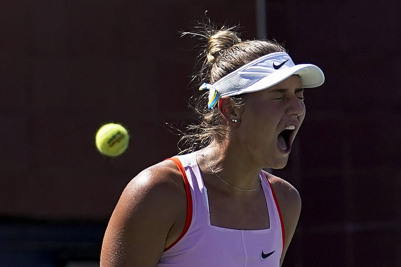 Marta Kostyuk, of Ukraine, reacts during a match against Victoria Azarenka, of Belarus, during the ...
