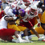 
              East Carolina's Keaton Mitchell (2) is wrapped up by North Carolina State's Travali Price (58), Drake Thomas (32) and Tanner Ingle (10) during the first half of an NCAA college football game in Greenville, N.C., Saturday, Sept. 3, 2022. (AP Photo/Karl B DeBlaker)
            