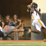 
              Oklahoma State safety Jason Taylor II (25) reaches out for Arkansas-Pine Bluff wide receiver Daemon Dawkins (7) as he bobbles a catch during the first half of an NCAA college football game, Saturday, Sept. 17, 2022, in Stillwater, Okla. (AP Photo/Brody Schmidt)
            