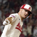 
              Los Angeles Angels' Mike Trout gestures as he rounds first after hitting a solo home run during the fifth inning of a baseball game against the Seattle Mariners Friday, Sept. 16, 2022, in Anaheim, Calif. (AP Photo/Mark J. Terrill)
            